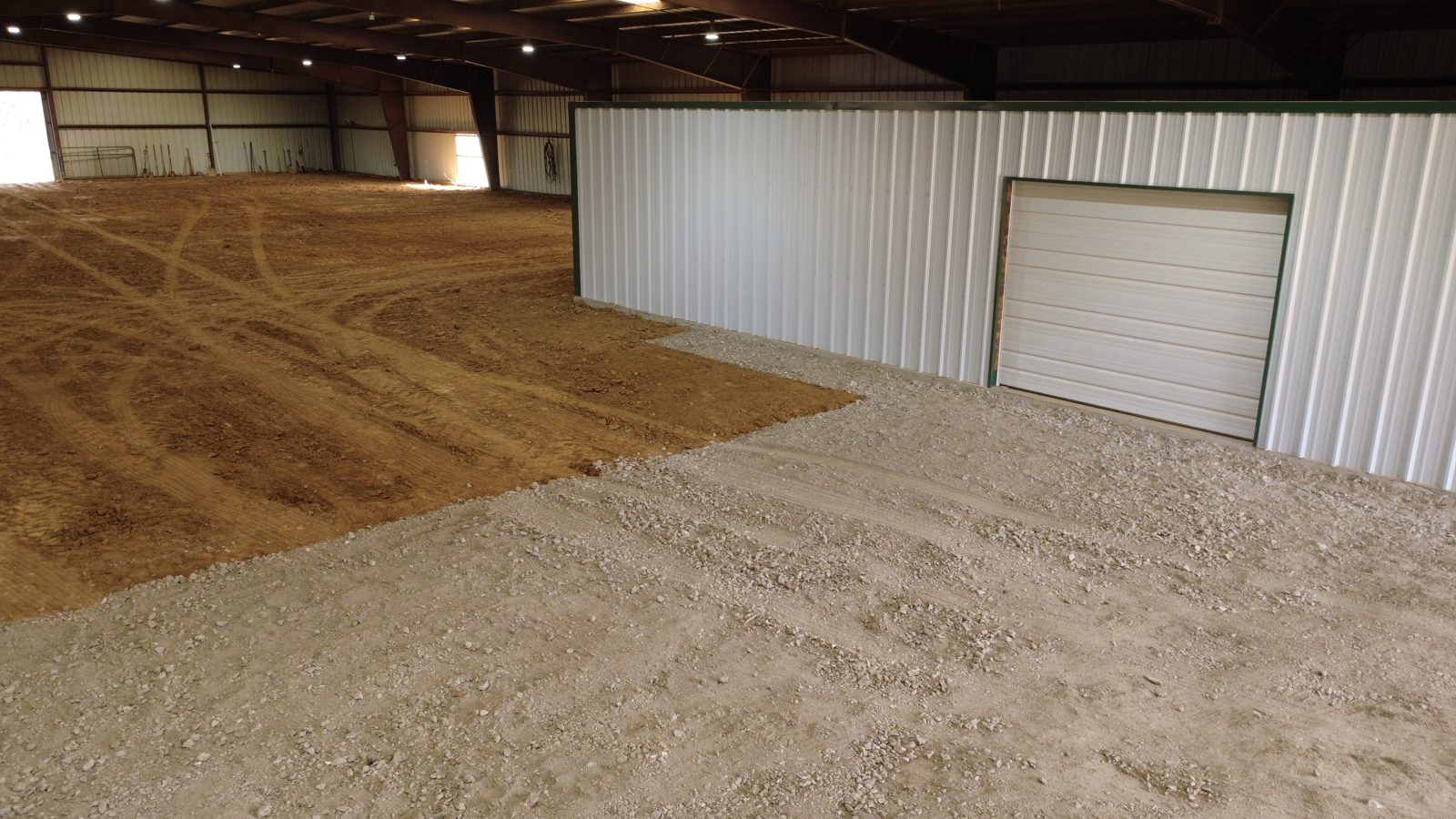 Metal building interior with the dirt floor graded and ready for the slab