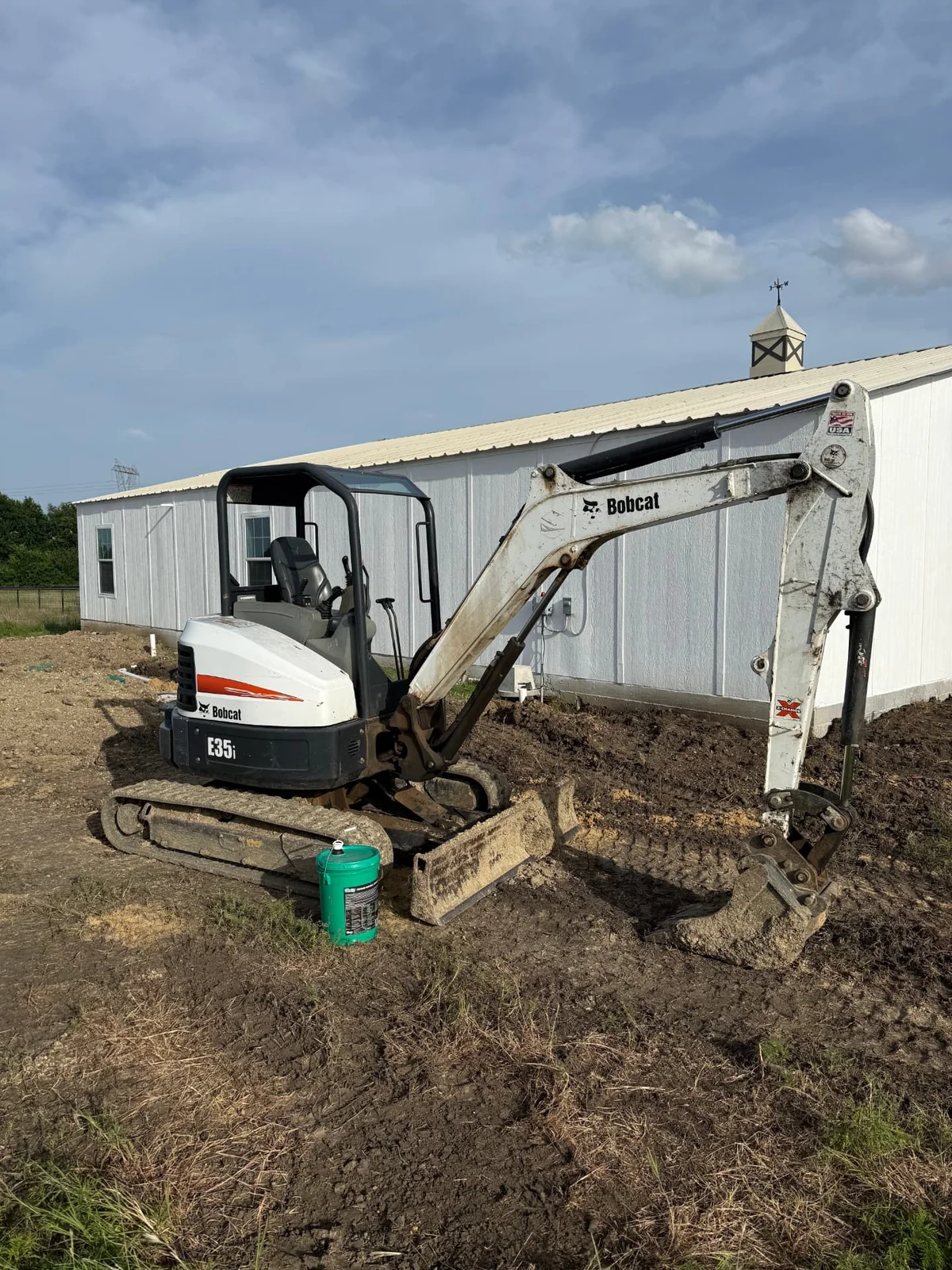 Bobcat E35 mini excavator digging for a septic tank installation at a barn in Weston, Texas