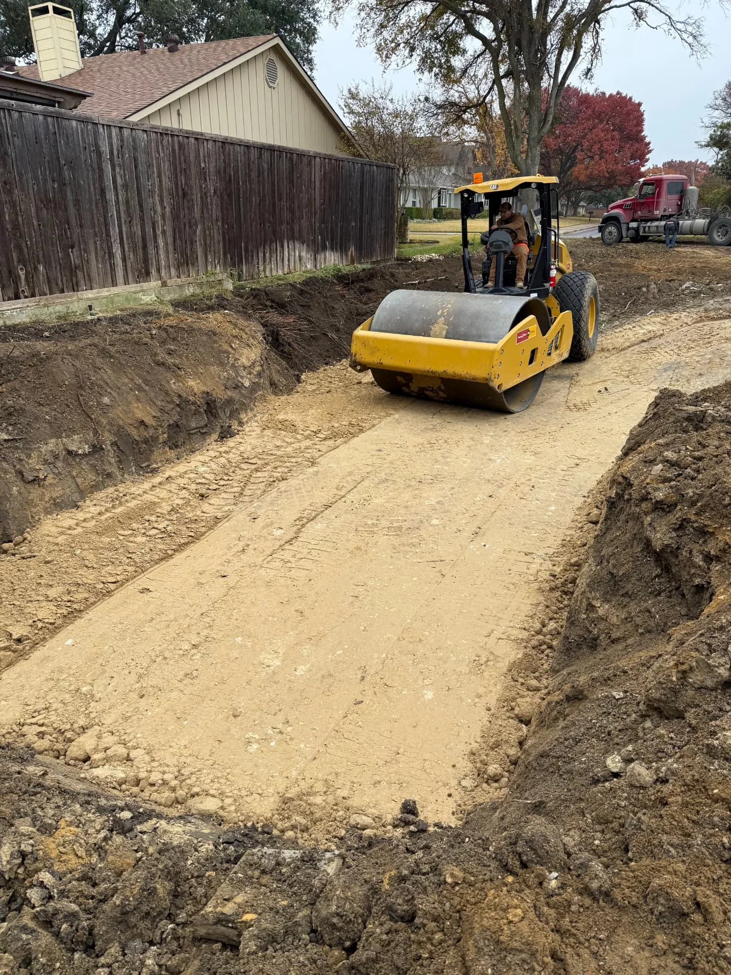 Select fill placed in lifts and compacted with a smooth drum roller inside a former pool cavity