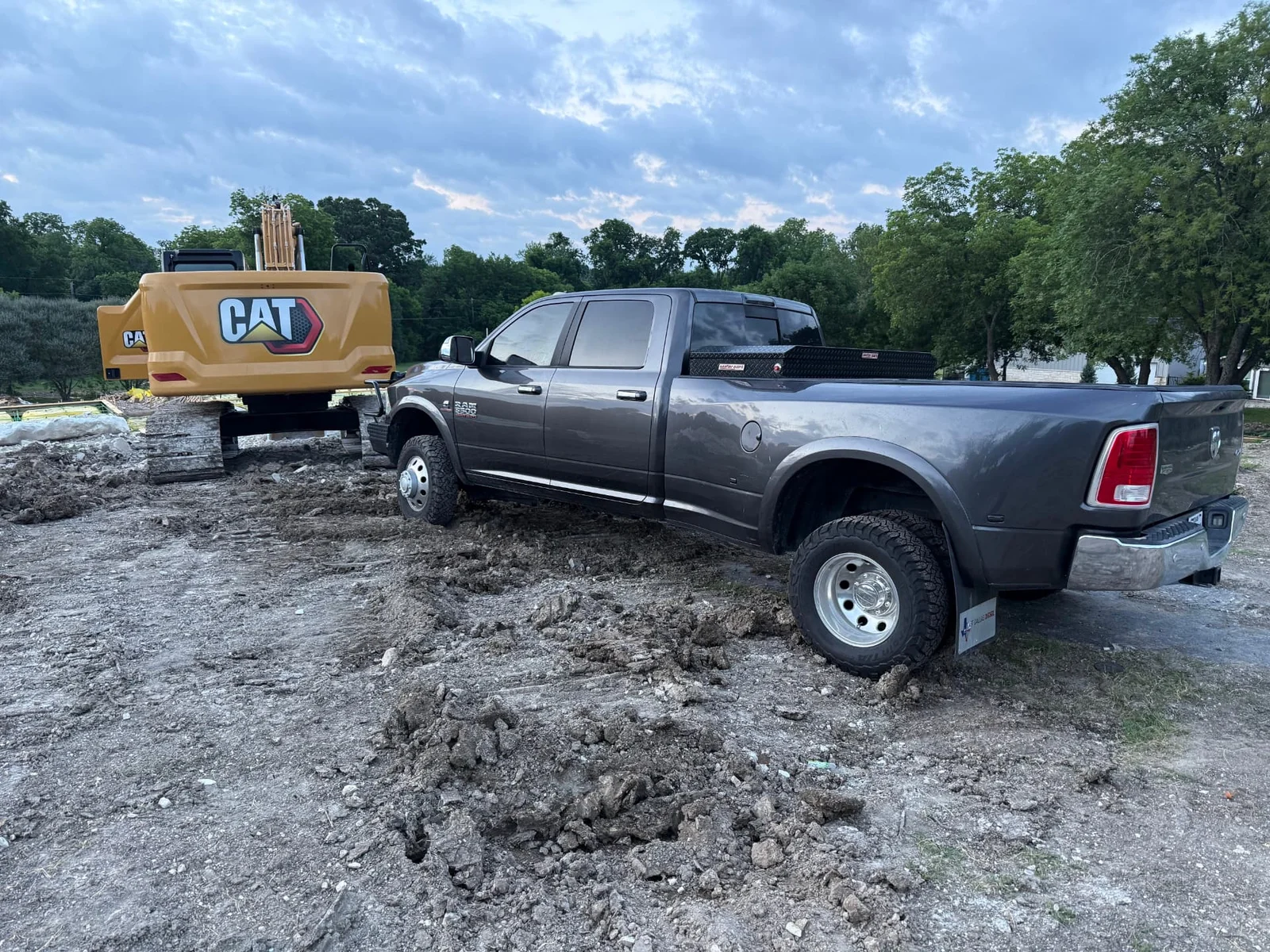 CAT excavator and work truck at a McKinney, Texas drainage ditch and culvert installation site