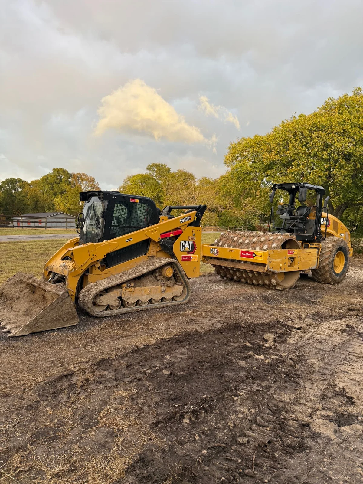 Skid steer and padfoot compactor building a house pad in Sherman, Texas