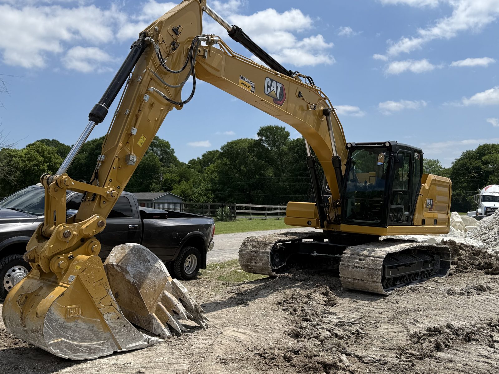 Tracked excavator working beside a spoil pile on a North Texas job